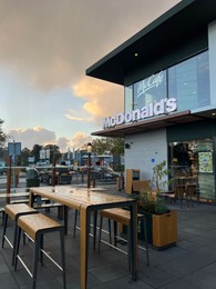 Leiden, Netherlands - October 15, 2023: Chairs and tables near McDonald's restaurant in city