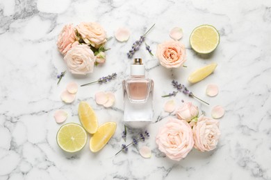 Photo of Flat lay composition with bottle of perfume and fresh citrus fruits on white marble table