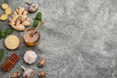 Flat lay composition with fresh products on grey table, space for text. Natural antibiotics