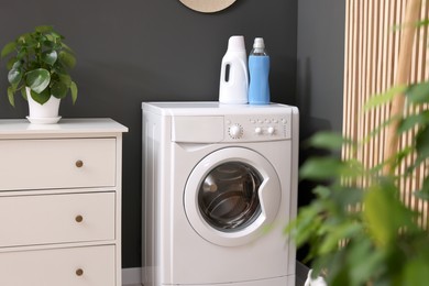 Photo of Laundry room interior with washing machine and furniture