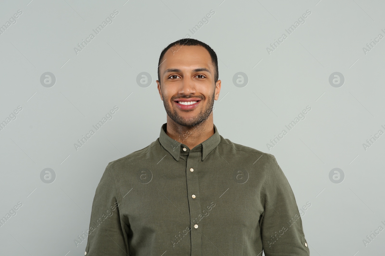 Photo of Portrait of handsome young man on gray background