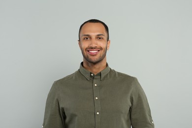 Photo of Portrait of handsome young man on gray background