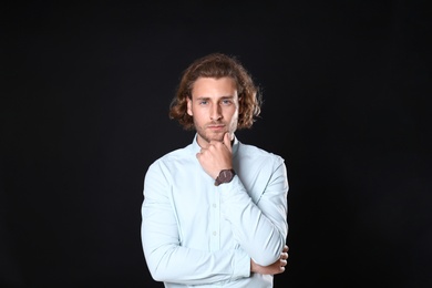 Portrait of handsome man on black background