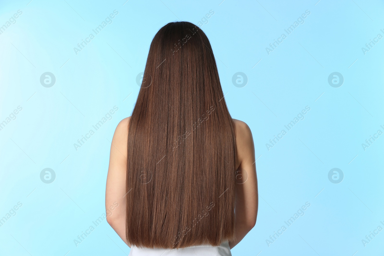 Photo of Woman with long brown hair on color background