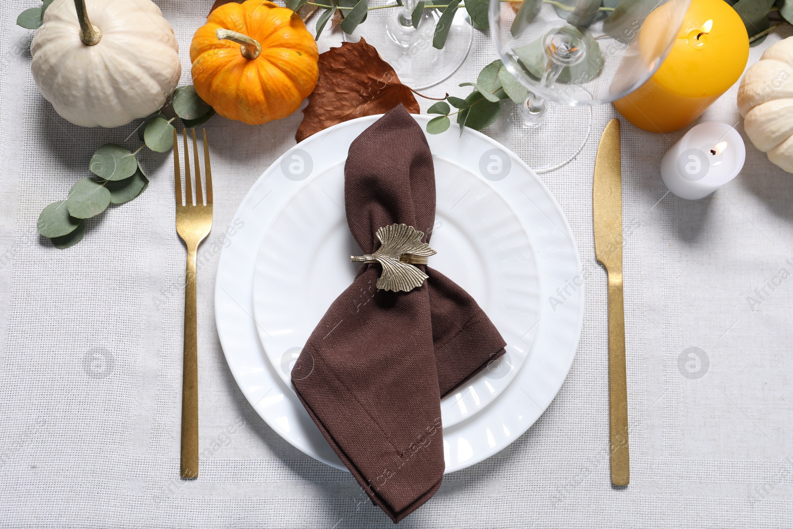 Photo of Beautiful autumn table setting. Plates, cutlery, glasses, pumpkins and floral decor, flat lay