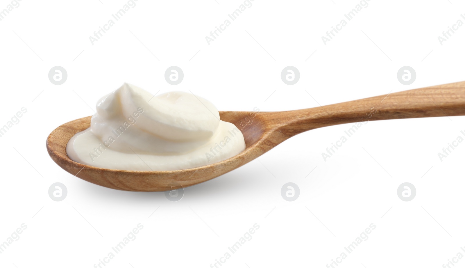 Photo of Sour cream in wooden spoon isolated on white