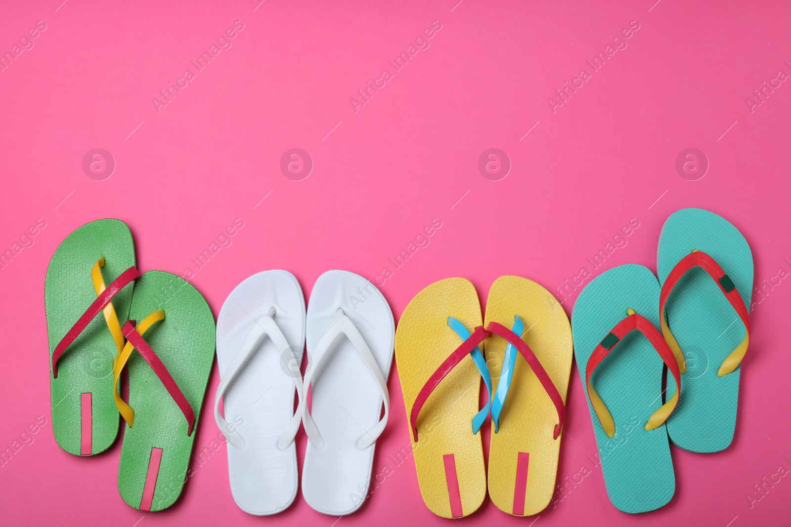 Photo of Many different flip flops on pink background, flat lay. Space for text