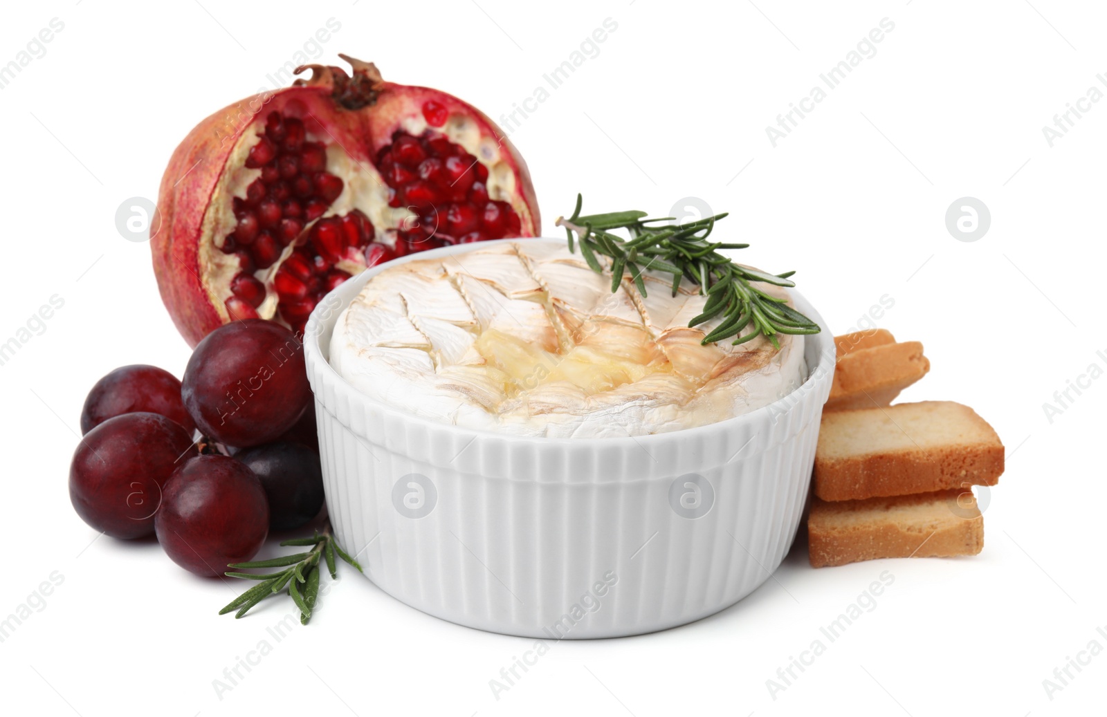 Photo of Tasty baked camembert, croutons, grapes and pomegranate isolated on white