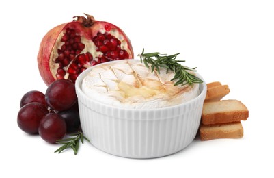 Tasty baked camembert, croutons, grapes and pomegranate isolated on white