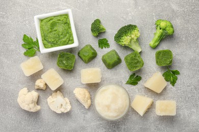 Photo of Frozen cauliflower and broccoli puree cubes with ingredients on light grey table, flat lay