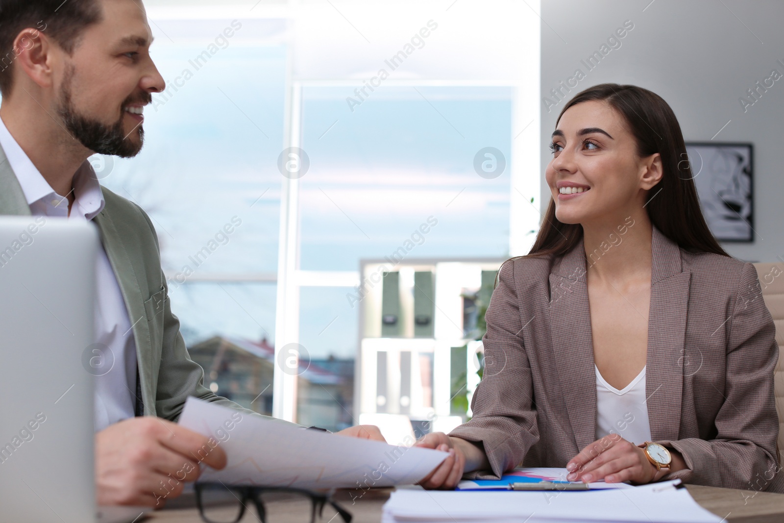 Photo of Office employees working with documents at table indoors