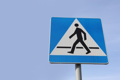 Traffic sign Pedestrian Crossing against blue sky, low angle view. Space for text