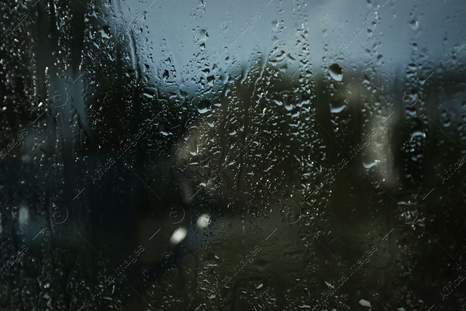 Photo of Blurred view from window on rainy day