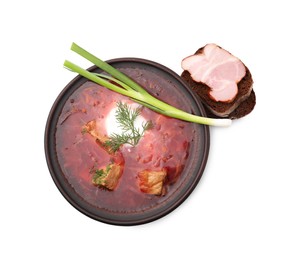 Photo of Tasty borscht, green onion and bread with ham isolated on white, top view