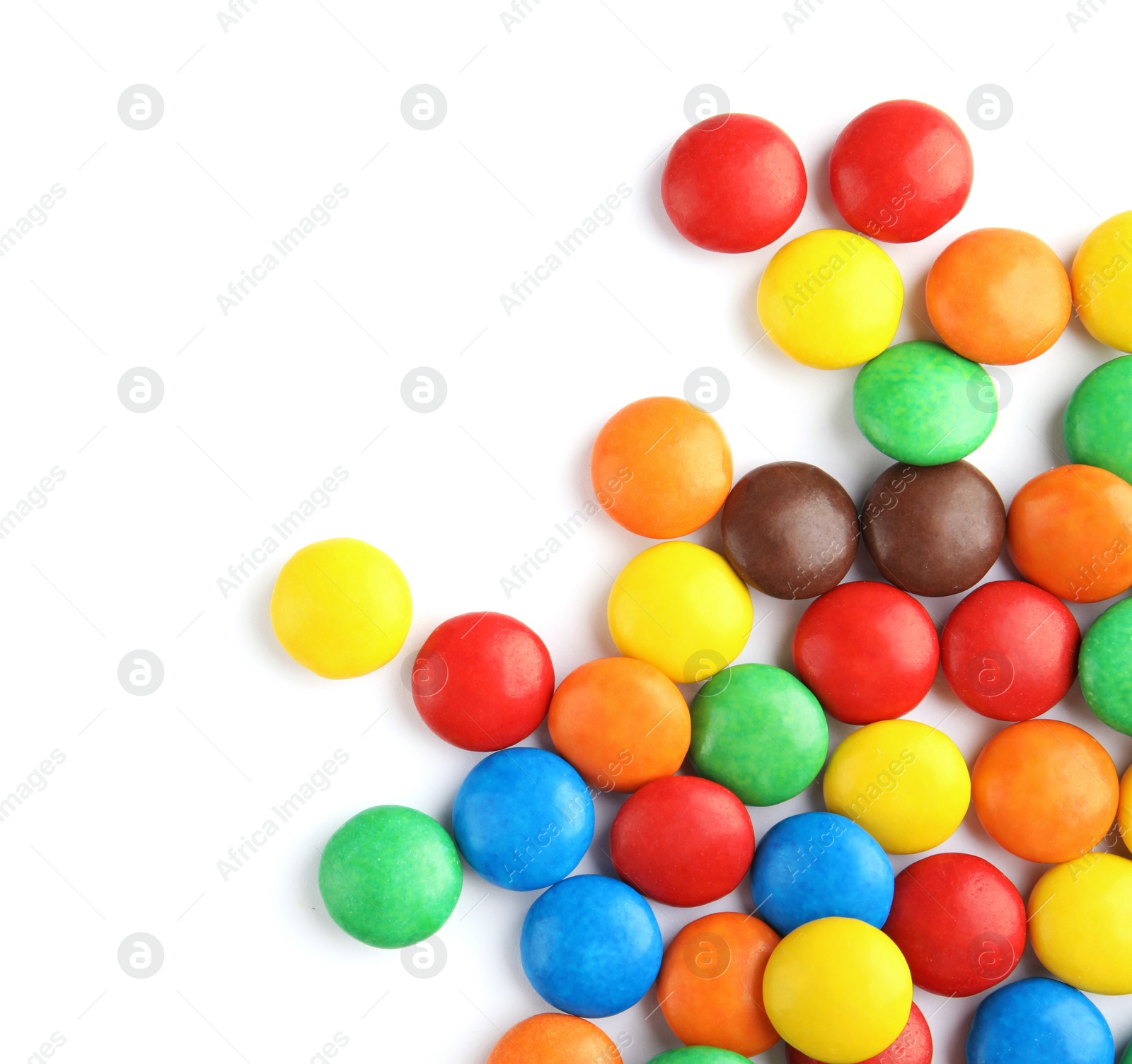 Photo of Tasty colorful candies on white background, top view