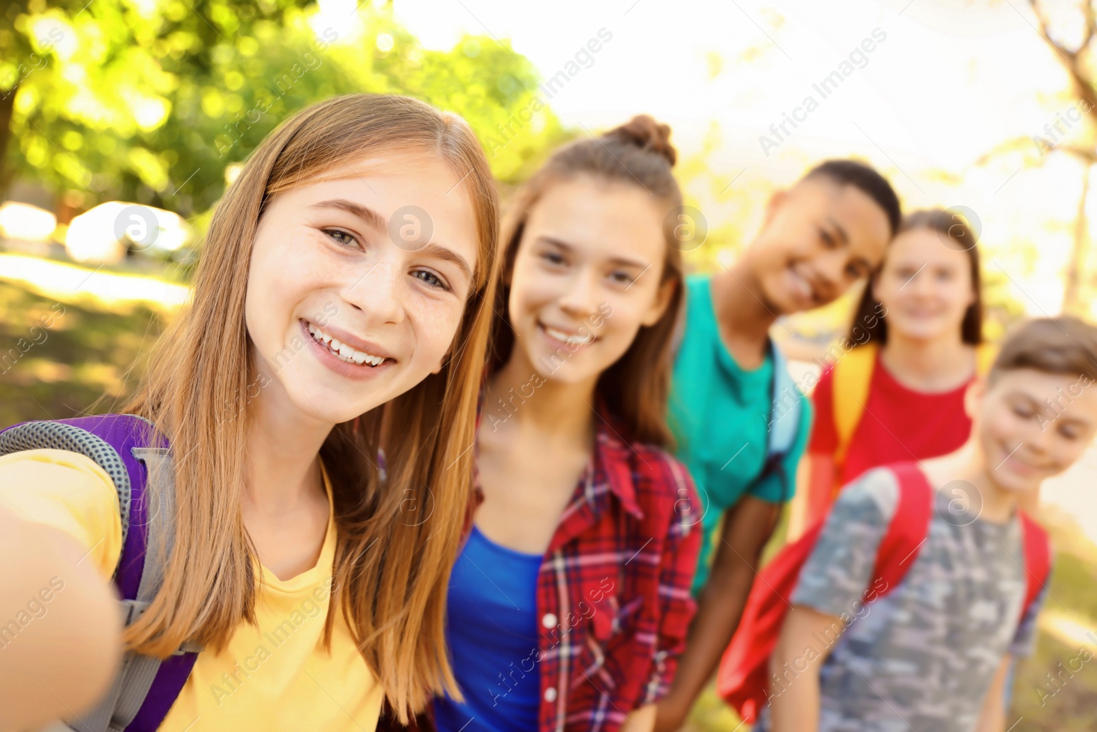 Photo of Group of children taking selfie outdoors. Summer camp