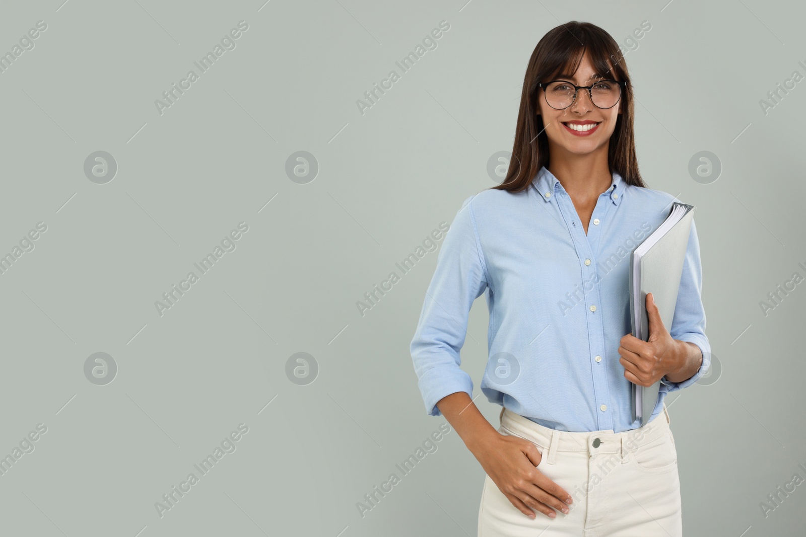 Photo of Happy secretary with folder on light grey background. Space for text