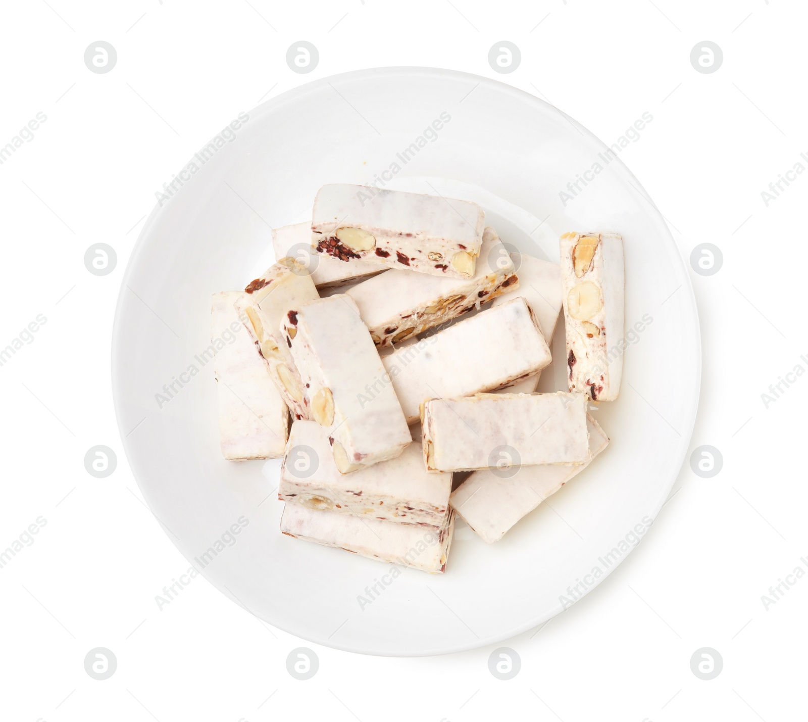 Photo of Plate with pieces of delicious nougat isolated on white, top view