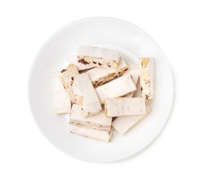 Plate with pieces of delicious nougat isolated on white, top view