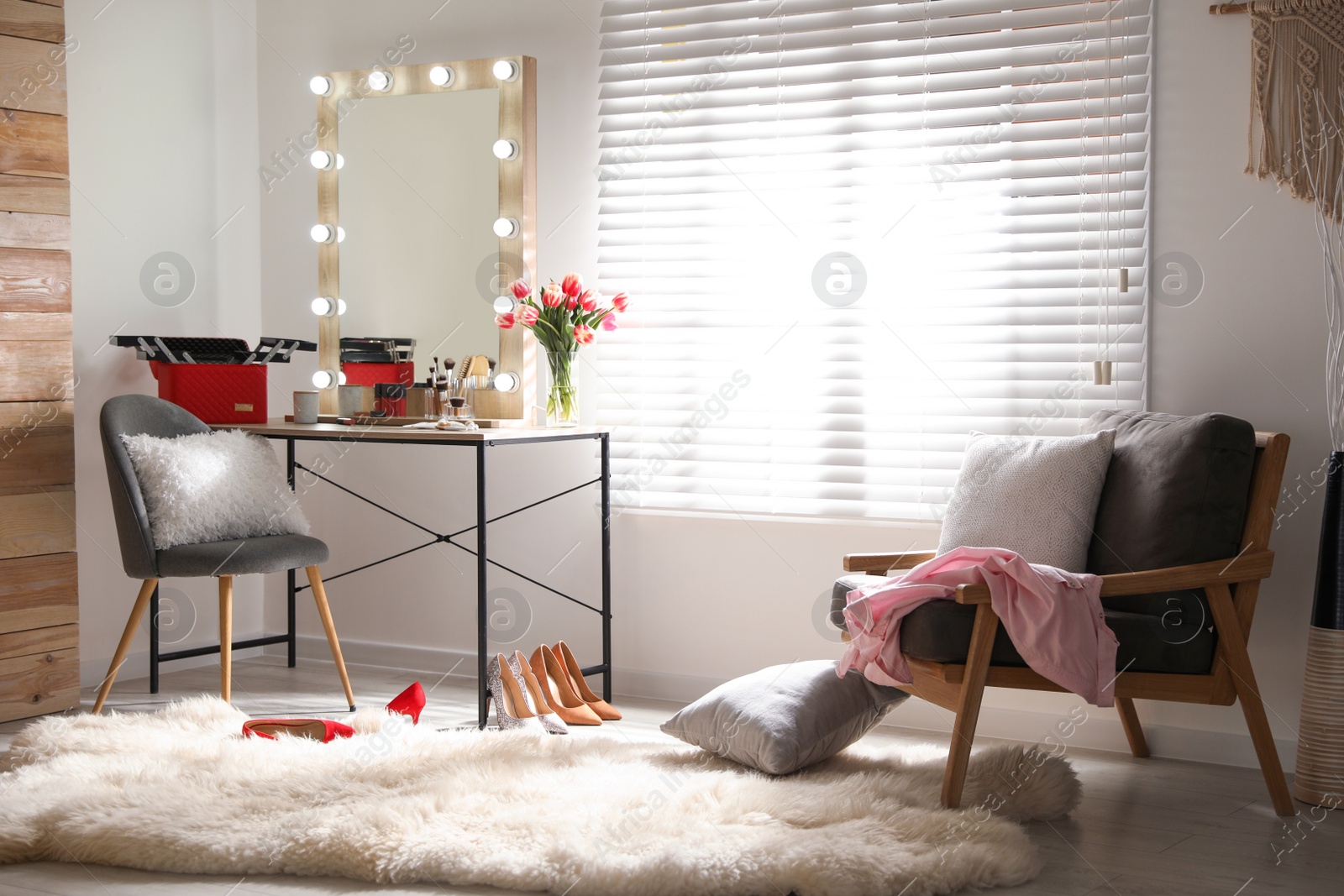 Photo of Dressing table and mirror with lamps in stylish room interior