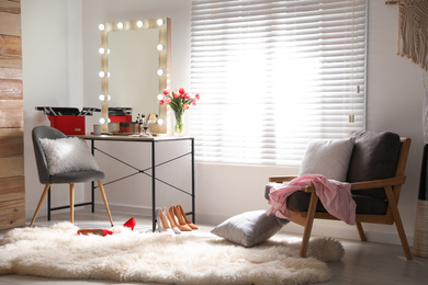 Photo of Dressing table and mirror with lamps in stylish room interior