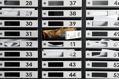 Photo of Many mailboxes with keyholes, numbers and correspondence as background