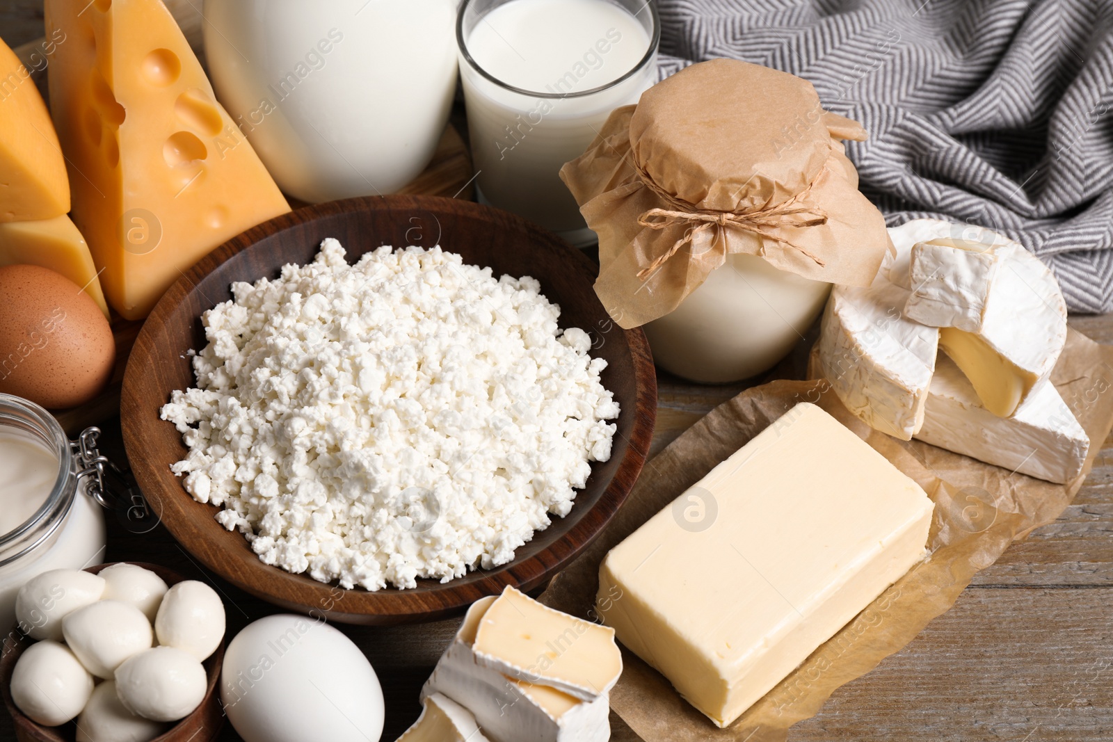 Photo of Different delicious dairy products on wooden table