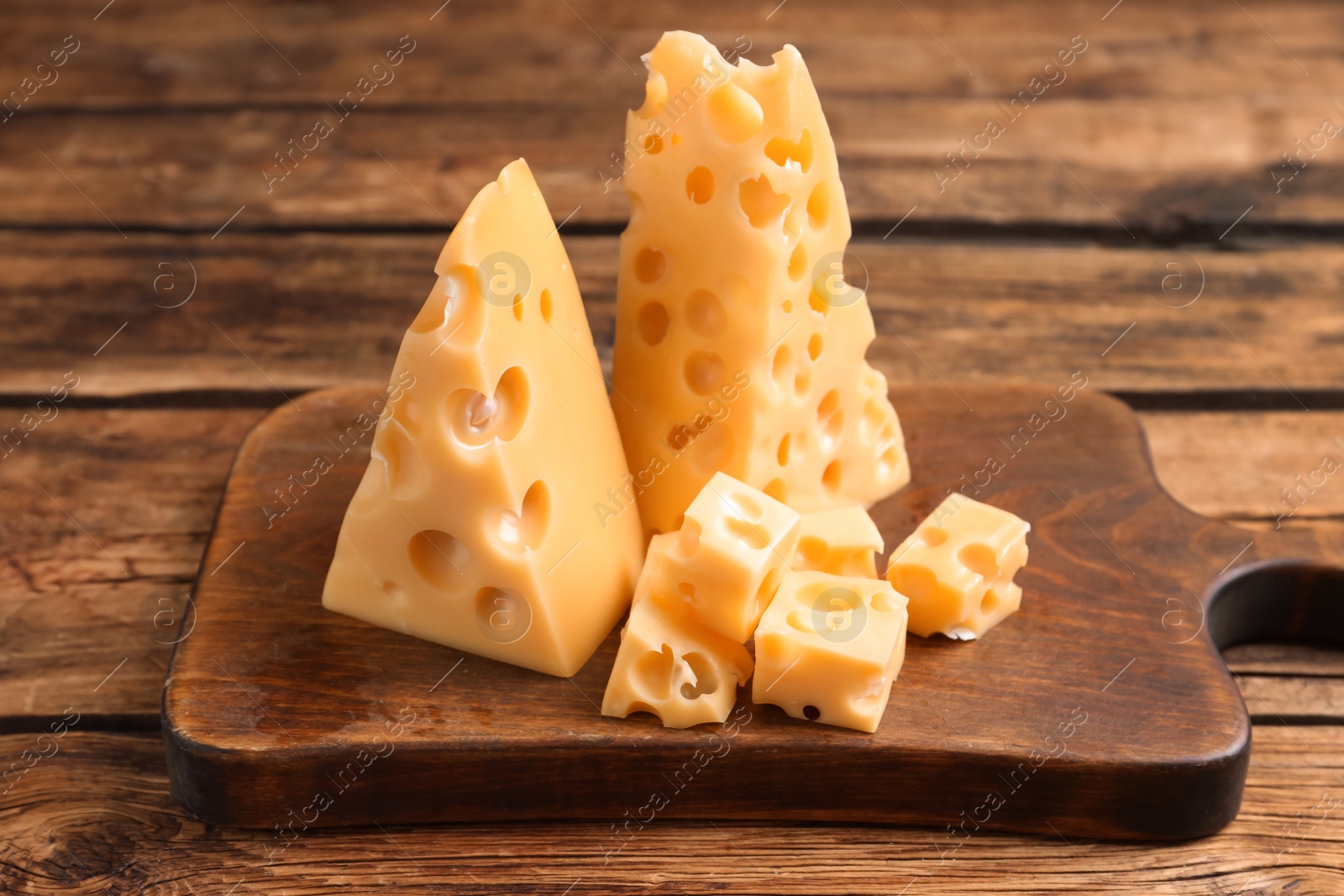 Photo of Tasty fresh cheese and board on wooden table,