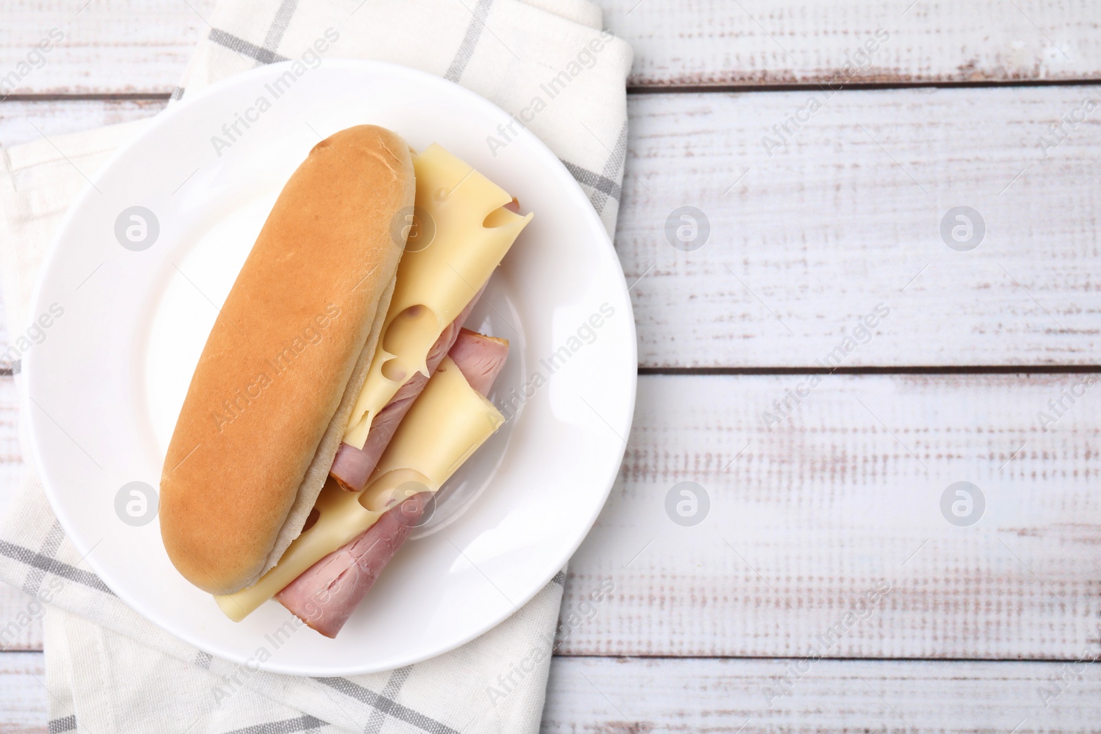 Photo of Delicious sandwich with ham and cheese on white wooden table, top view. Space for text