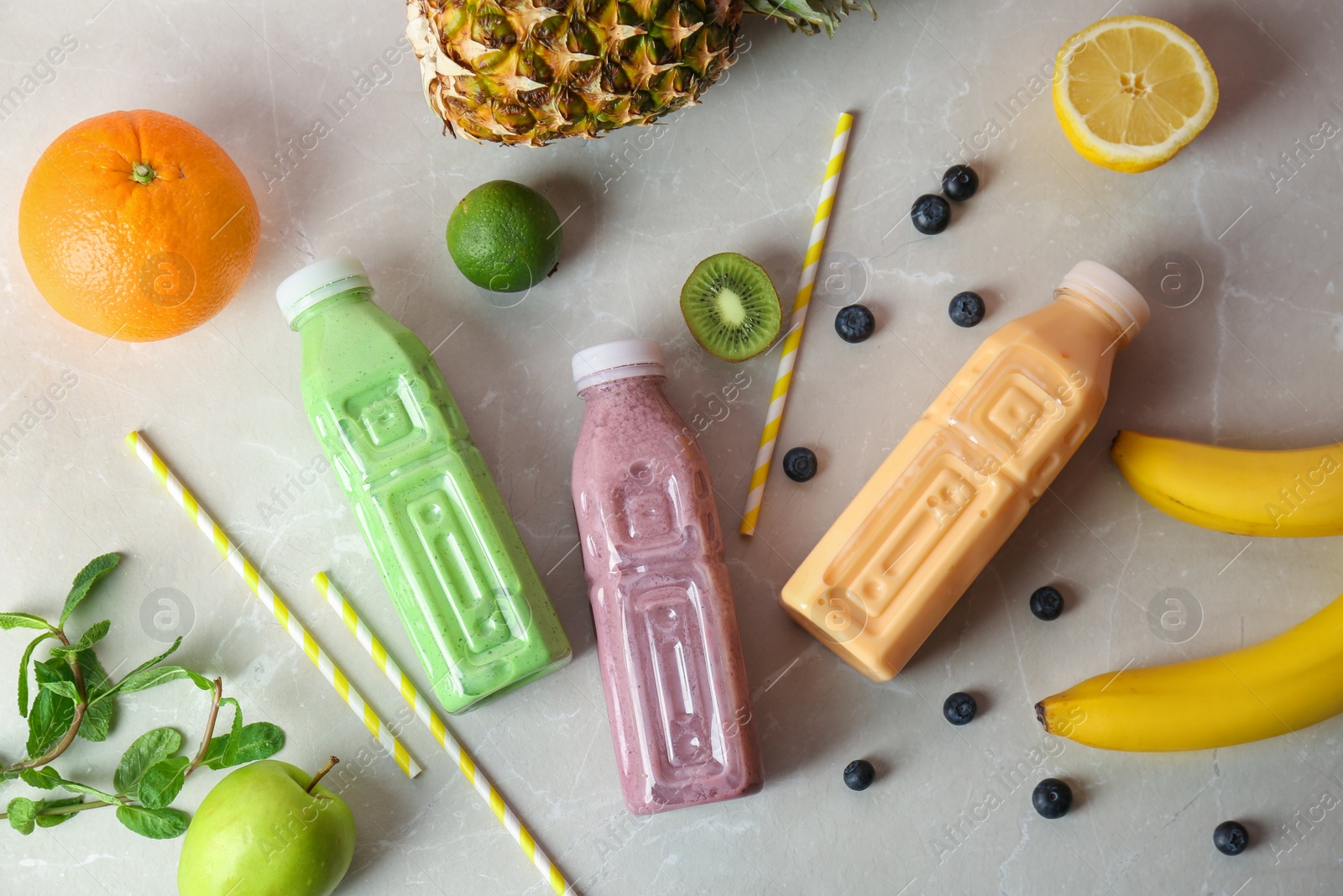 Photo of Flat lay composition with healthy detox smoothies and ingredients on grey background