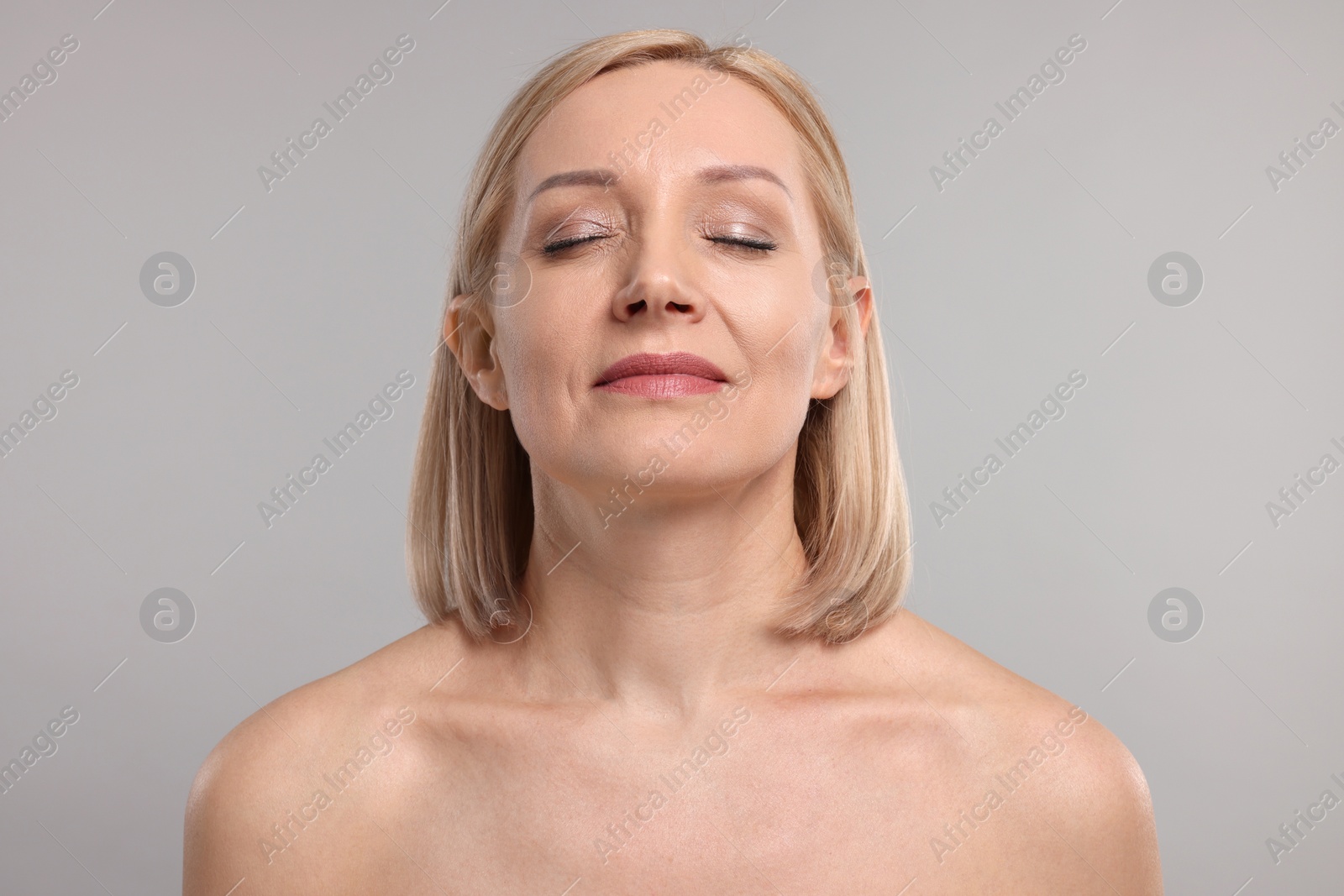 Photo of Beautiful woman with healthy skin on grey background