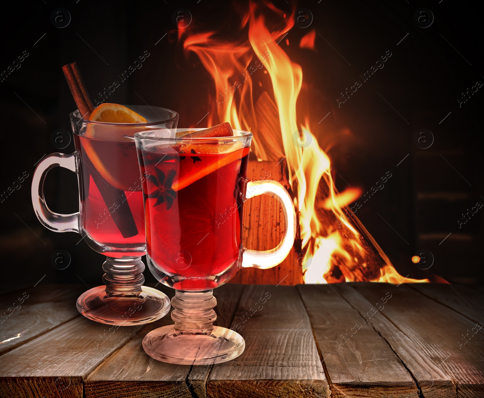 Image of Mulled wine on wooden table near fireplace