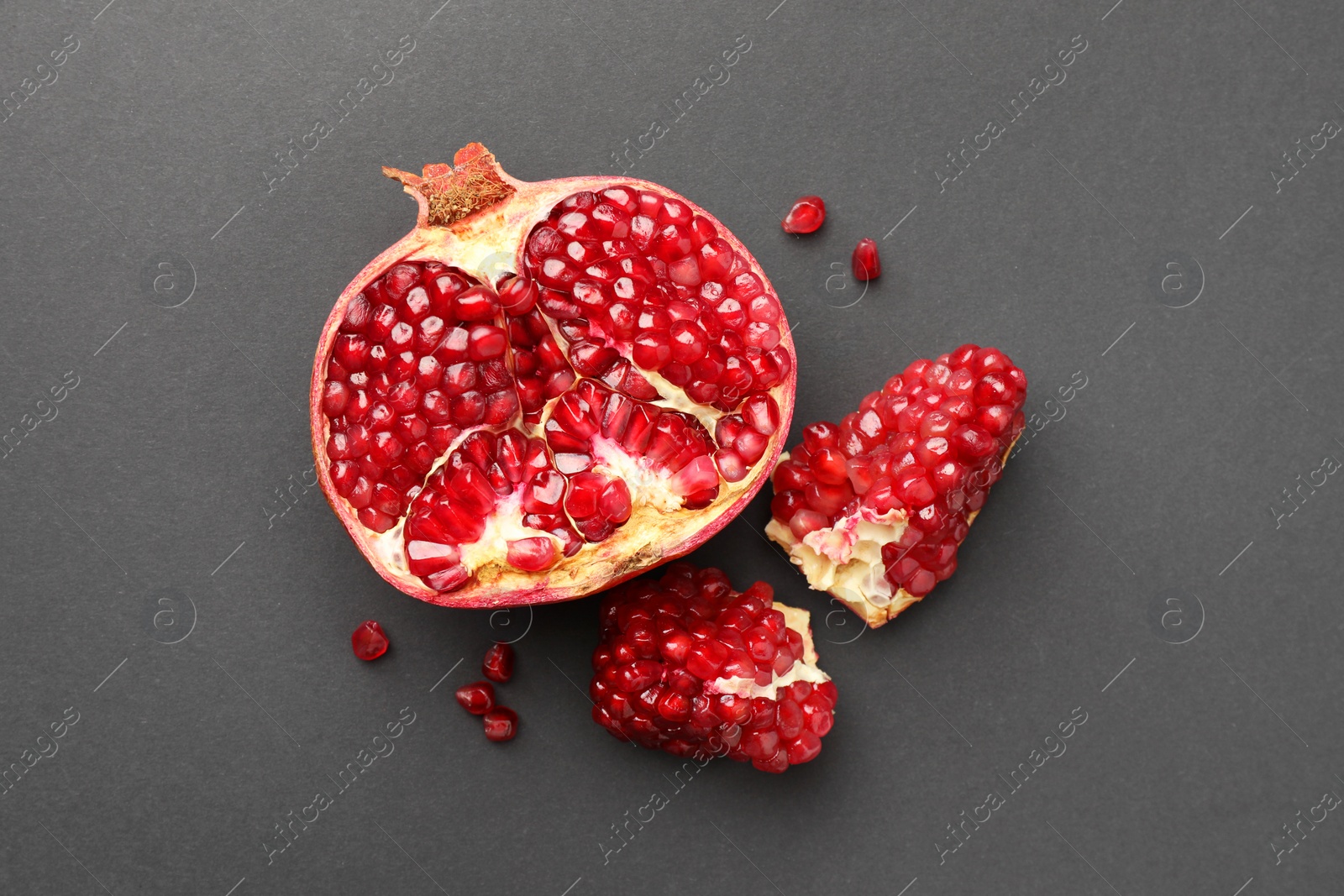 Photo of Fresh ripe pomegranate on grey background, top view