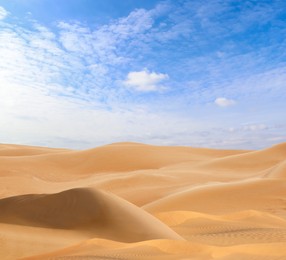 Image of Picturesque view of sandy desert and blue sky on hot sunny day 