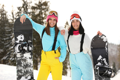 Photo of Young snowboarders wearing winter sport clothes outdoors