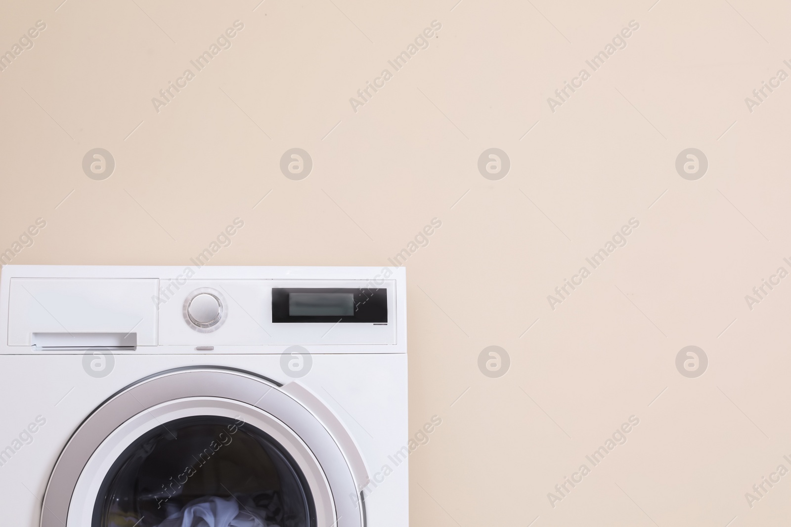 Photo of Washing machine and space for text on color background. Laundry day