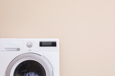 Photo of Washing machine and space for text on color background. Laundry day