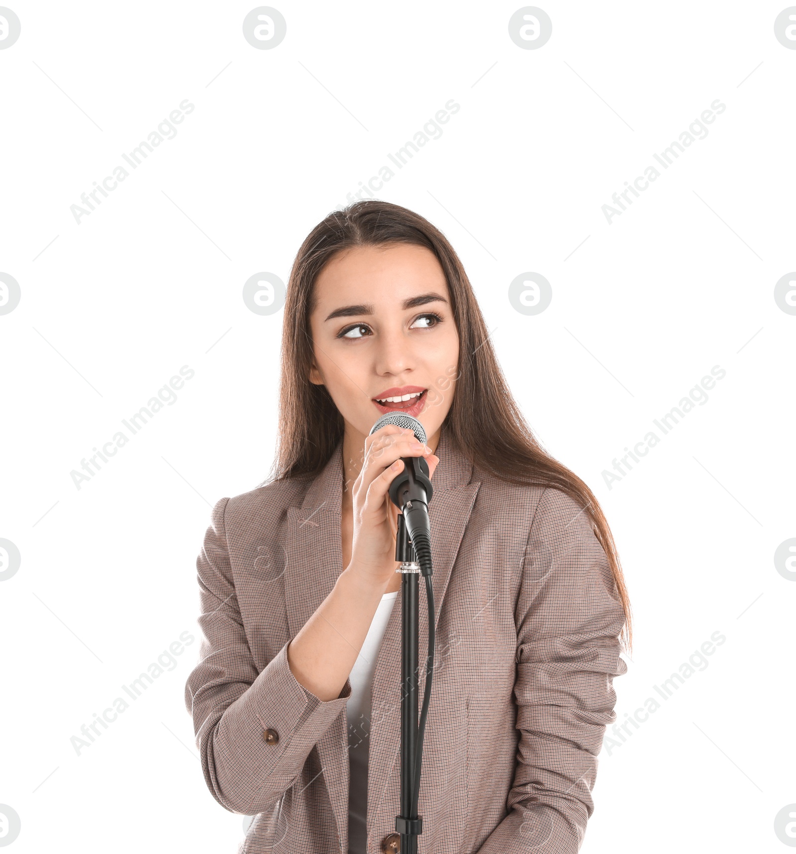 Photo of Young stylish woman singing in microphone on white background