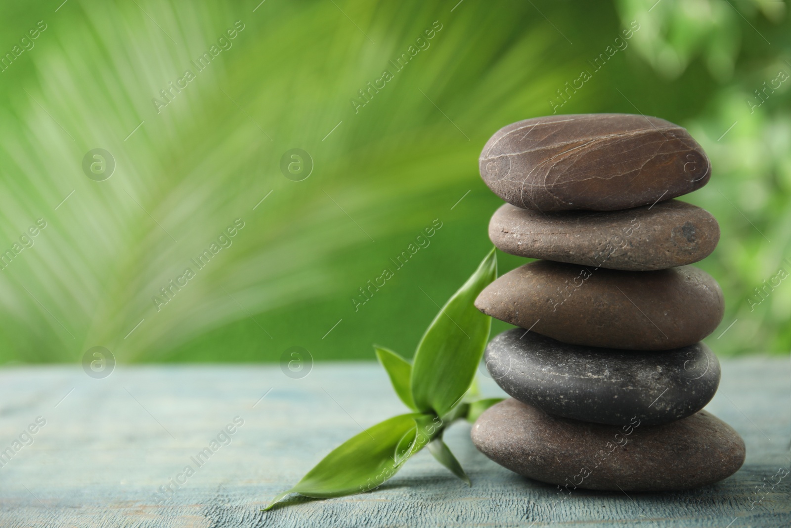 Photo of Composition with stones on table against blurred background. Zen concept