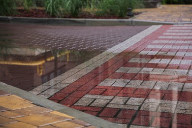 Photo of Puddle after rain on street tiles outdoors