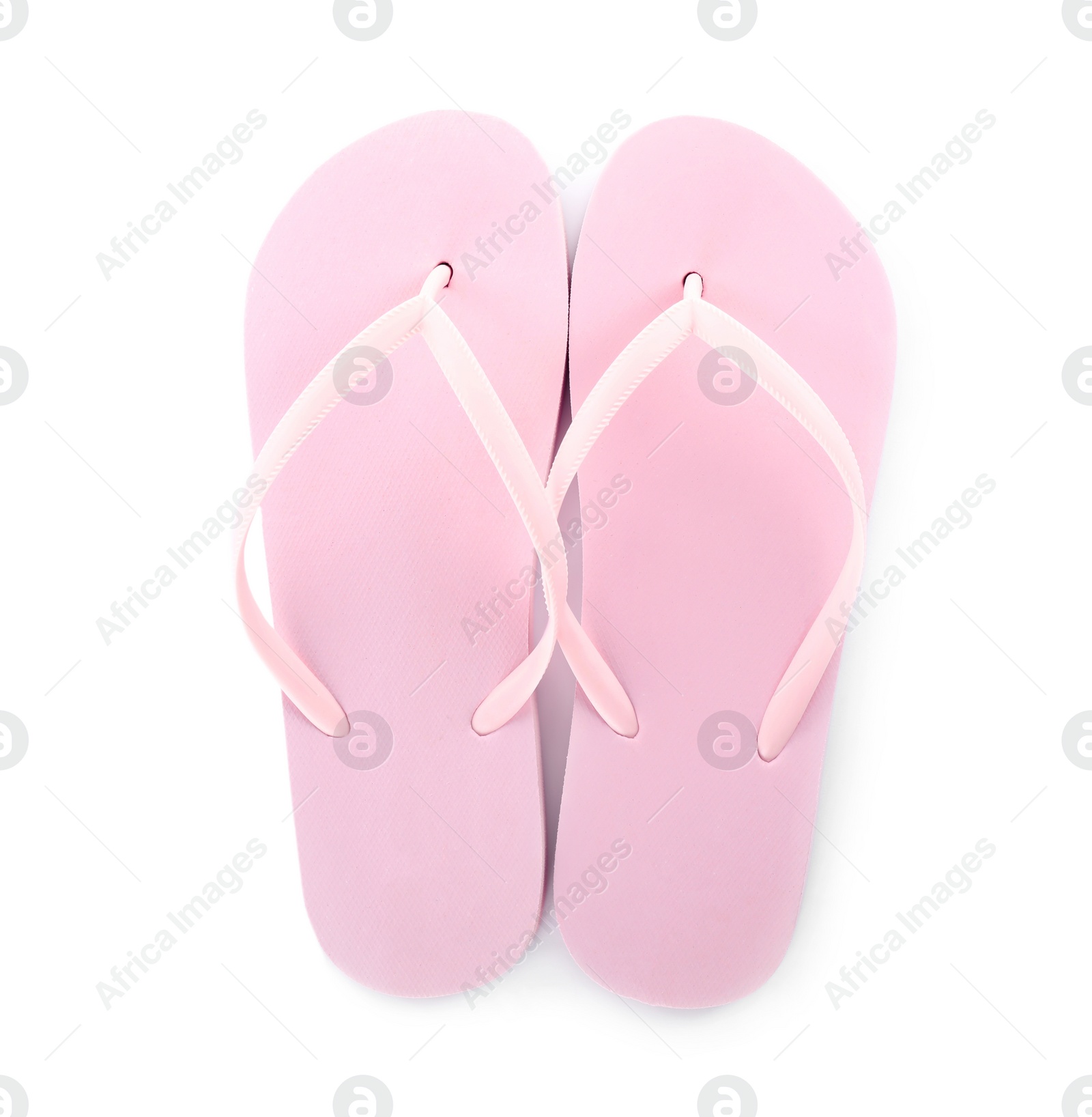 Photo of Light pink flip flops isolated on white, top view. Beach accessory