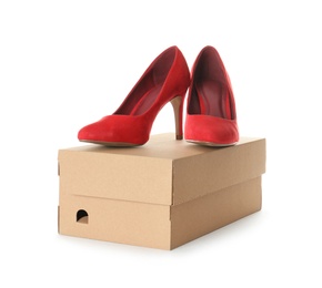 Photo of Pair of stylish high heel shoes and carton box on white background