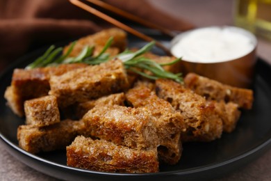 Photo of Crispy rusks with rosemary on plate, closeup