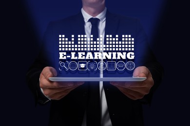 Image of E-learning. Man holding tablet on dark background, closeup. Illustrations of different icons