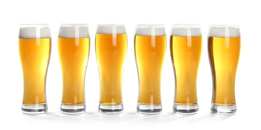 Photo of Glasses of beer on white background