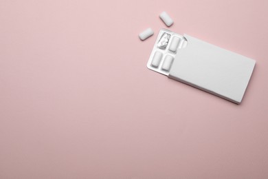 Photo of Blister with chewing gums on pink background, top view. Space for text