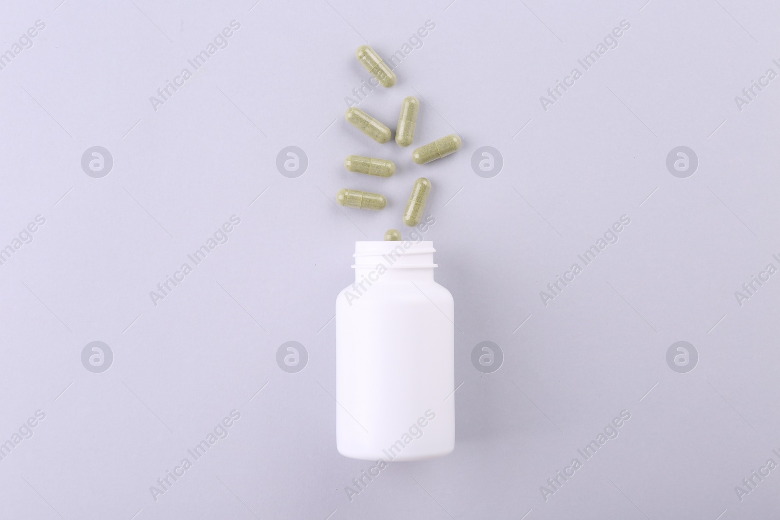 Photo of Jar with vitamin capsules on white background, top view