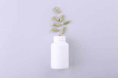 Photo of Jar with vitamin capsules on white background, top view