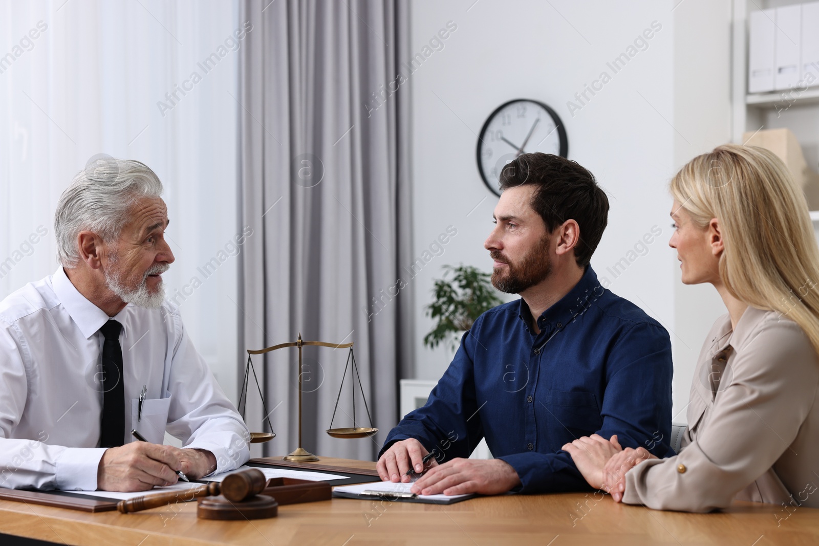 Photo of Couple having meeting with lawyer in office