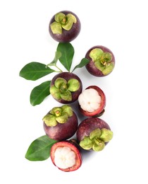 Photo of Fresh ripe mangosteen fruits with green leaves on white background, top view